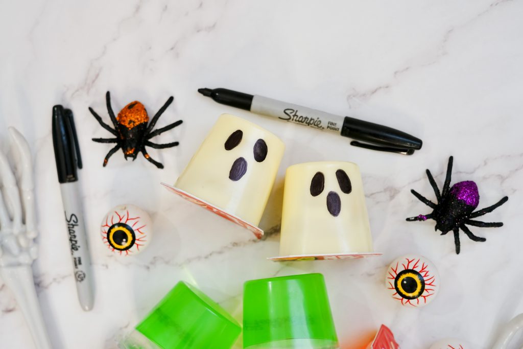 use a sharpie marker to draw two black eyes and mouth on Vanilla Jello Pudding cups to make ghosts