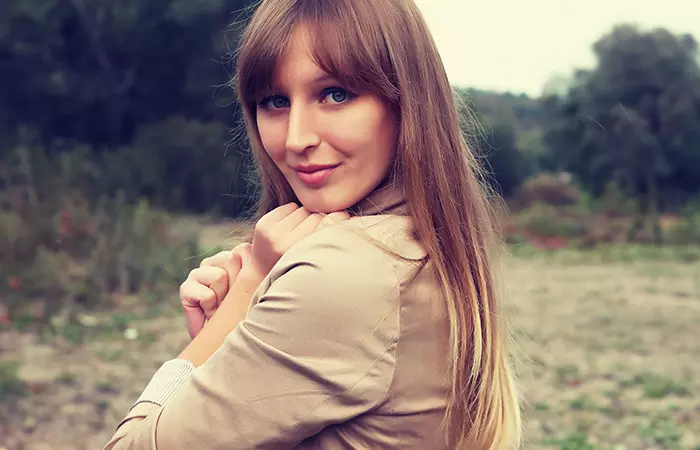 A happy woman with curtain bangs